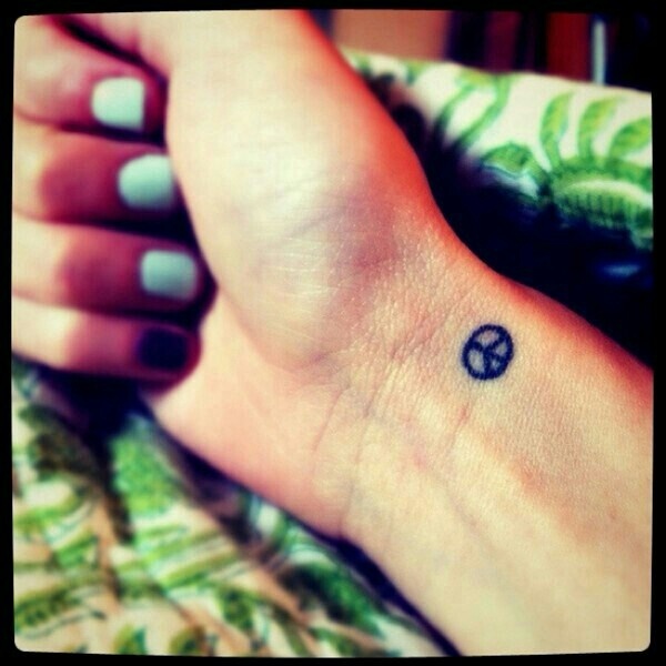 peace sign wrist tattoo